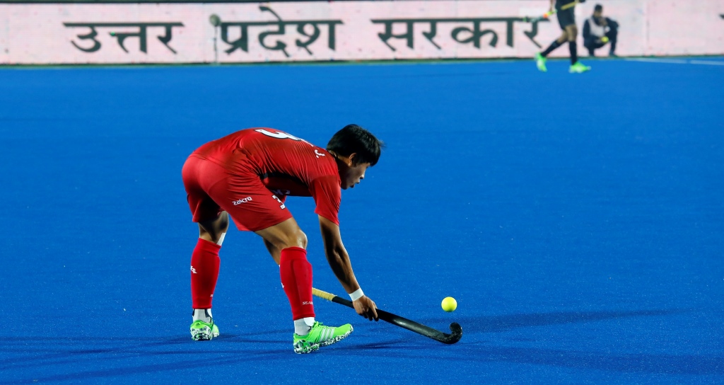 A hockey player about to hit the ball in Junior Men's Hockey world cup match at Lucknow, India