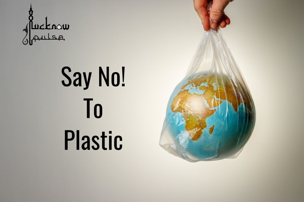 A globe in a plastic carrybag. Text caption: Say No to Plastic. LucknowPulse